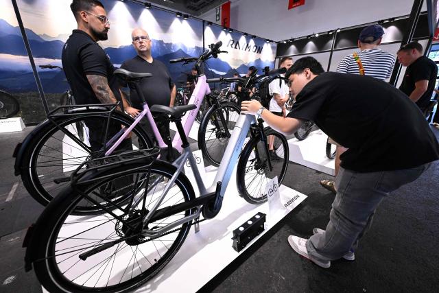 Electric bikes are seen at the booth of Raymon at the EUROBIKE 2026 fair of the international bicycle industry in Frankfurt am Main, western Germany on June 24, 2026. According to the organisers, more than 1,500 exhibitors of the bicycle and ecomobility industry from 60 countries will present their products and services during the fair running from June 24 to June 27, 2026. (Photo by Kirill KUDRYAVTSEV / AFP)