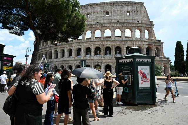 Tourists queue to fill their bottles at a public fountain displaying still and sparkling refrigerated water for free, near the Colosseum on June 24, 2026 (Photo by Andreas SOLARO / AFP)