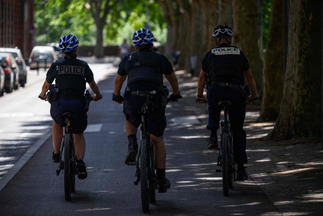 Policemen ride their bikes under a shade on the banks of the Garonne river in Toulouse on June 24, 2026, as a heatwave hits France. (Photo by Lionel BONAVENTURE / AFP)