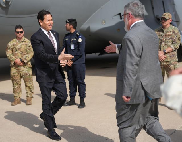 US Secretary of State Marco Rubio is greeted by Steven Butler, charge d'affaires ad interim of the US embassy in Kuwait, after arriving on a US Air Force C-17 Globemaster III transport aircraft at Kuwait International Airport during his visit to the Middle East to discuss the interim deal between the US and Iran with Arab Gulf allies, in Kuwait City on June 24, 2026. Rubio arrived in the United Arab Emirates on June 23, and held talks with its leader flying to Kuwait and then Bahrain, where he will attend a Gulf Cooperation Council (GCC) meeting. Rubio's trip is the first by a senior US official to the Middle East since the Iran agreement was signed last week. (Photo by Eric Lee / POOL / AFP)