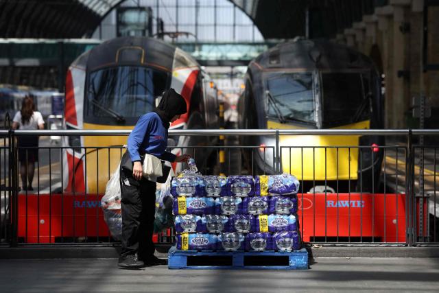 Stacks of water bottles are laid out for people to take at Kings Cross station in central London on June 24, 2026. The UK's meteorological office has issued an extremely rare red heat warning -- only issued once before -- for June24 and 25, as temperatures could soar to 40C, unprecedented for the time of the year. (Photo by Toby Shepheard / AFP)