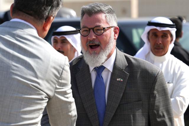 Steven Butler, charge d'affaires ad interim of the US embassy in Kuwait, greets a member of staff travelling with the US  Secretary of State, after arriving on a US Air Force C-17 Globemaster III transport aircraft at Kuwait International Airport during his visit to the Middle East to discuss the interim deal between the US and Iran with Arab Gulf allies, in Kuwait City on June 24, 2026. Rubio arrived in the United Arab Emirates on June 23, and held talks with its leader flying to Kuwait and then Bahrain, where he will attend a Gulf Cooperation Council (GCC) meeting. Rubio's trip is the first by a senior US official to the Middle East since the Iran agreement was signed last week. (Photo by Eric Lee / POOL / AFP)