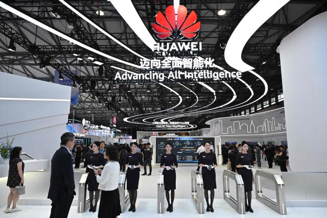 People visit the Huawei booth during the Mobile World Congress (MWC) in Shanghai on June 24, 2026. (Photo by HECTOR RETAMAL / AFP)
