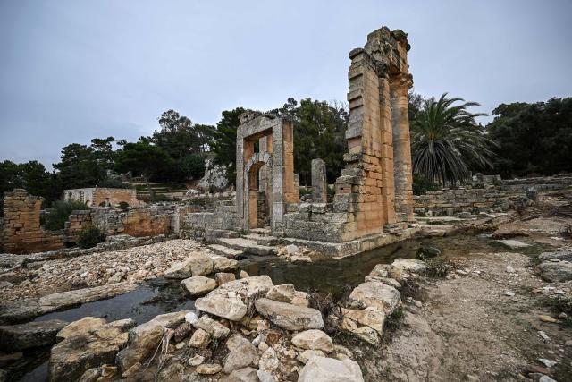 (FILES) Water flows through the ruins at the site of the ancient Greco-Roman city of Cyrene (Shahat) in eastern Libya, about 60 kilometres (37 miles) west of Derna, on September 21, 2023, in the aftermath of a devastating flood. In eastern Libya's ancient ruins of Cyrene and Apollonia -- targeted by jihadist groups and later ravaged by Storm Daniel -- a small group of passionate archaeologists have taken it upon themselves to safeguard the sites. The UNESCO-listed ruins were once the heart of a unique network of Greek colonies in North Africa. (Photo by Ozan KOSE / AFP)