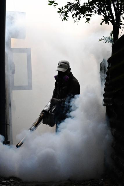 A municipal worker fumigates a residential area during a nationwide dengue prevention campaign in Colombo on June 24, 2026. (Photo by Ishara S. KODIKARA / AFP)