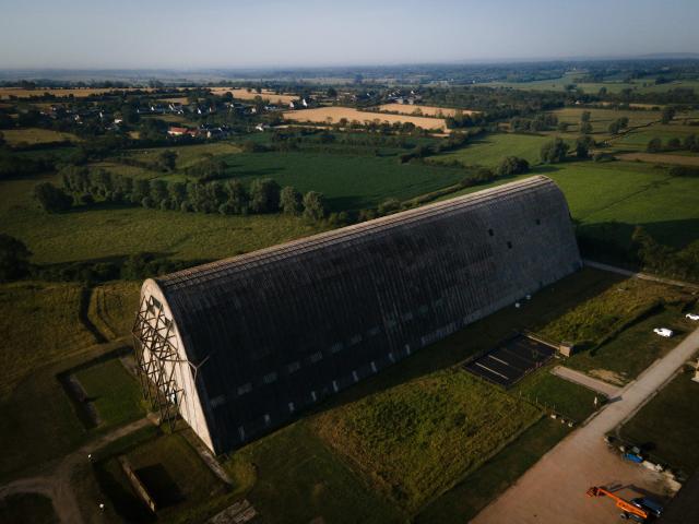 This aerial photograph taken on June 24, 2026 shows the Ecausseville's airship hangar, in Ecausseville, western France. (Photo by Lou BENOIST / AFP)