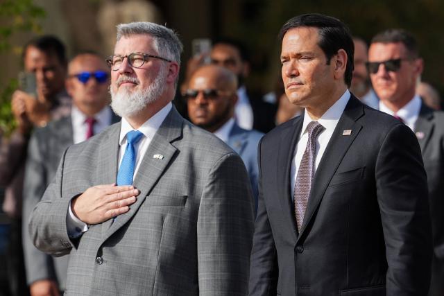 US Secretary of State Marco Rubio (R) and Steven Butler, charge d'affaires ad interim of the US embassy in Kuwait, attend a flag raising ceremony at the US Embassy during Rubio's visit to the Middle East to discuss the interim deal between the U.S. and Iran with Arab Gulf allies, in Kuwait City on June 24, 2026. Rubio arrived in the United Arab Emirates on June 23, and held talks with its leader flying to Kuwait and then Bahrain, where he will attend a Gulf Cooperation Council (GCC) meeting. Rubio's trip is the first by a senior US official to the Middle East since the Iran agreement was signed last week. (Photo by Eric Lee / POOL / AFP)