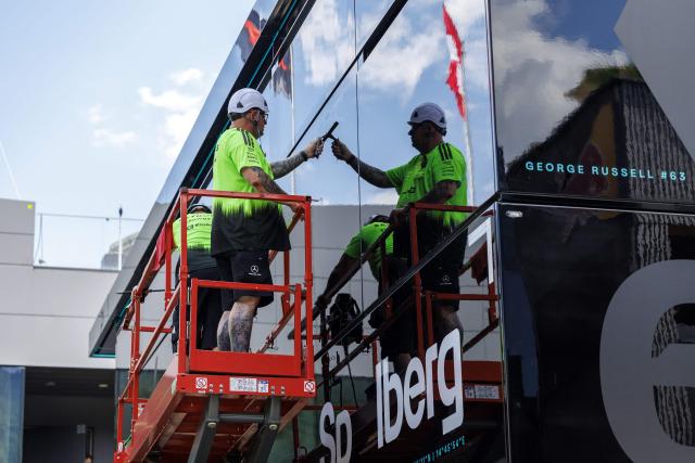 Workers stand on a hydraulic platform during preparations and contruction work at the paddock of Mercedes' British driver George Russell at the Red Bull Ring race track in Spielberg, Austria on June 24, 2026, ahead of the Formula One Austrian Grand Prix. (Photo by ERWIN SCHERIAU / APA / AFP) / Austria OUT