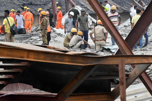 Rescue workers search for survivors and victims following a collapse at an under-construction warehouse in Kolkata's Taratala area on June 24, 2026. (Photo by Dibyangshu SARKAR / AFP)