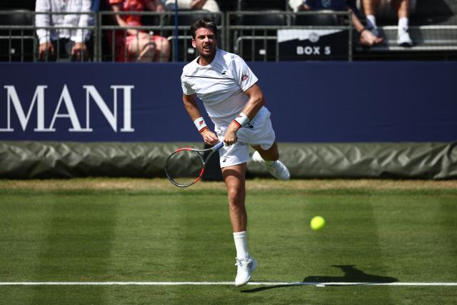 Britain's Cameron Norrie serves against Italy's Jannik Sinner during their men's singles exhibition match during the Giorgio Armani Tennis Classic tournament at the Hurlingham Club in London on June 24, 2026. (Photo by Henry Nicholls / AFP)