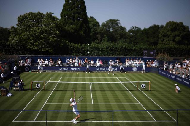 Italy's Jannik Sinner throws the ball to serve against Britain's Cameron Norrie during their men's singles exhibition match during the Giorgio Armani Tennis Classic tournament at the Hurlingham Club in London on June 24, 2026. (Photo by Henry NICHOLLS / AFP)