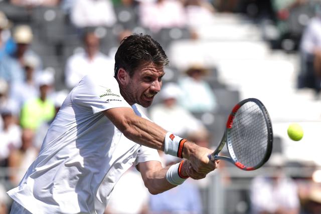 Britain's Cameron Norrie returns to Italy's Jannik Sinner during their men's singles exhibition match during the Giorgio Armani Tennis Classic tournament at the Hurlingham Club in London on June 24, 2026. (Photo by Henry NICHOLLS / AFP)