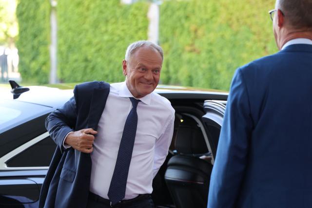 German Chancellor Friedrich Merz (R) welcomes Polish Prime Minister Donald Tusk as he arrives for a meeting with state leaders of the European Group of Five (E5) and the NATO Secretary General on June 24, 2026 at the Chancellery in Berlin, Germany. (Photo by Ludovic MARIN / AFP)