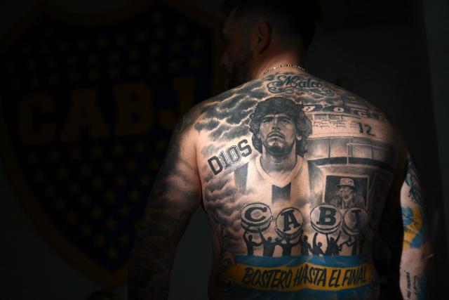 Hernan Hvala, 43, poses shows a tattoo depicting late Argentine football legend Diego Maradona in Buenos Aires on June 23, 2026, during the FIFA World Cup 2026. (Photo by Luis ROBAYO / AFP)