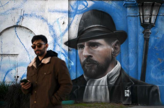 A man walks near a mural depicting Argentine football star Lionel Messi in Buenos Aires on June 24, 2026, during the FIFA World Cup 2026. (Photo by Luis ROBAYO / AFP)