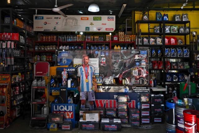 A life-size cardboard cutout depicting Argentine football star Lionel Messi is seen at an oil and lubricant store in La Boca neighborhood, Buenos Aires on June 19, 2026, during the FIFA Word Cup 2026. (Photo by Luis ROBAYO / AFP)