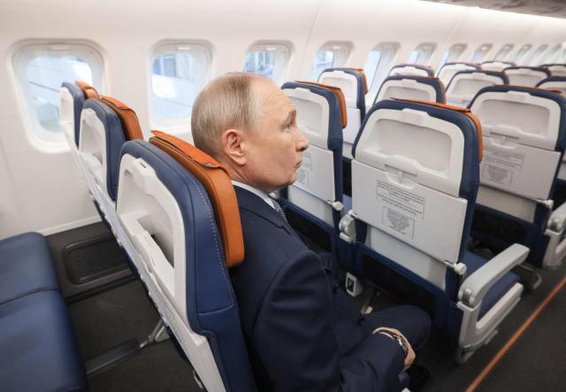 In this pool photograph distributed by the Russian state agency Sputnik, Russia's President Vladimir Putin inspects a Yakovlev SJ-100 short-haul jet aircraft at the Flight Research Institute named after M.M. Gromov in Zhukovsky in the Moscow region on June 24, 2026. (Photo by Mikhail METZEL / POOL / AFP)