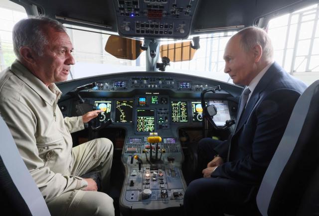 In this pool photograph distributed by the Russian state agency Sputnik, Russia's President Vladimir Putin inspects an Ilyushin IL-114-300 regional passenger turboprop aircraft at the Flight Research Institute named after M.M. Gromov in Zhukovsky in the Moscow region on June 24, 2026. (Photo by Mikhail METZEL / POOL / AFP)