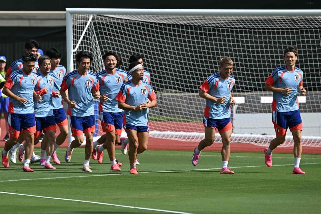 Japan players warm up during a training session on the eve of the 2026 World Cup football tournament Group F football match between Japan and Sweden at Dallas Stadium training facility in Dallas on June 24, 2026. (Photo by Paul ELLIS / AFP)