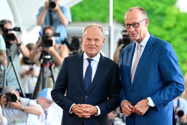 German Chancellor Friedrich Merz (R) welcomes Polish Prime Minister Donald Tusk as he arrives for a meeting with state leaders of the European Group of Five (E5) and the NATO Secretary General on June 24, 2026 at the Chancellery in Berlin, Germany. (Photo by John MACDOUGALL / AFP)