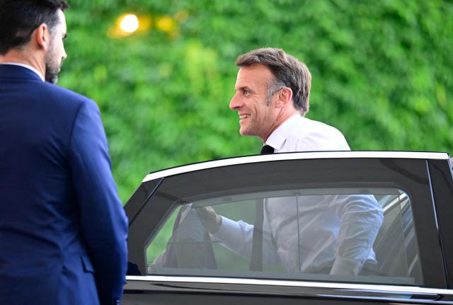 France's President Emmanuel Macron (R) arrives for a meeting with state leaders of the European Group of Five (E5) and the NATO Secretary General on June 24, 2026 at the Chancellery in Berlin, Germany. (Photo by John MACDOUGALL / AFP)