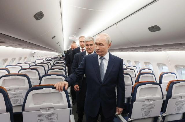 In this pool photograph distributed by the Russian state agency Sputnik, Russia's President Vladimir Putin inspects a Yakovlev SJ-100 short-haul jet aircraft at the Flight Research Institute named after M.M. Gromov in Zhukovsky in the Moscow region on June 24, 2026. (Photo by Mikhail METZEL / POOL / AFP)
