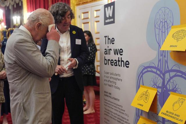 Britain's King Charles III uses a handkerchief to dab his forehead dry as he attends a London Climate Week reception, hosted by the Department for Energy Security and Net Zero (DESNZ), at St James's Palace, London on June 24, 2026. (Photo by Yui Mok / POOL / AFP)
