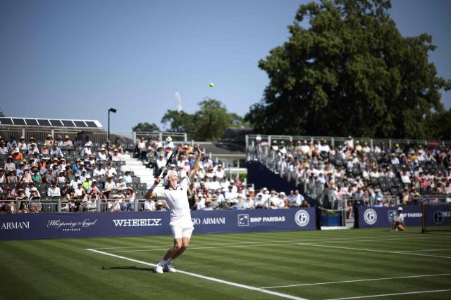 Italy's Jannik Sinner throws the ball to serve against Britain's Cameron Norrie during their men's singles exhibition match during the Giorgio Armani Tennis Classic tournament at the Hurlingham Club in London on June 24, 2026. (Photo by Henry NICHOLLS / AFP)