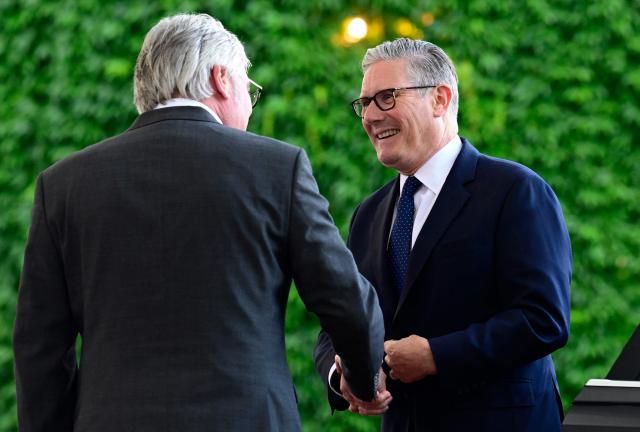 Britain's Prime Minister Keir Starmer (R) arrives for a meeting with state leaders of the European Group of Five (E5) and the NATO Secretary General on June 24, 2026 at the Chancellery in Berlin, Germany. (Photo by John MACDOUGALL / AFP)
