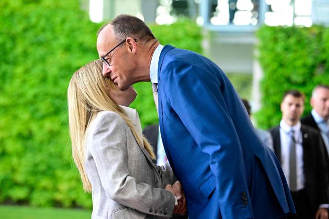 German Chancellor Friedrich Merz (R) welcomes Italy's Prime Minister Giorgia Meloni as he arrives for a meeting with state leaders of the European Group of Five (E5) and the NATO Secretary General on June 24, 2026 at the Chancellery in Berlin, Germany. (Photo by Tobias SCHWARZ / AFP)