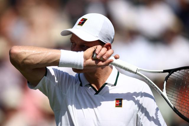 Italy's Jannik Sinner wipes sweat from his face as he plays Britain's Cameron Norrie during their men's singles exhibition match during the Giorgio Armani Tennis Classic tournament at the Hurlingham Club in London on June 24, 2026. (Photo by Henry Nicholls / AFP)