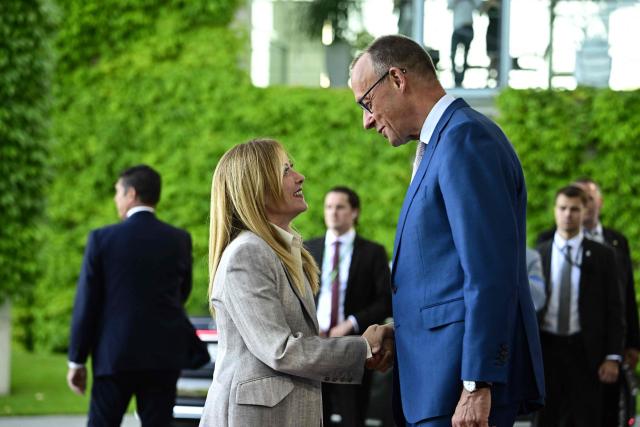 German Chancellor Friedrich Merz (R) welcomes Italy's Prime Minister Giorgia Meloni as he arrives for a meeting with state leaders of the European Group of Five (E5) and the NATO Secretary General on June 24, 2026 at the Chancellery in Berlin, Germany. (Photo by Tobias SCHWARZ / AFP)