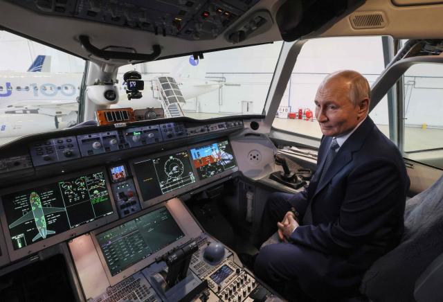 In this pool photograph distributed by the Russian state agency Sputnik, Russia's President Vladimir Putin inspects a Yakovlev MC-21 medium-haul airliner at the Flight Research Institute named after M.M. Gromov in Zhukovsky in the Moscow region on June 24, 2026. (Photo by Mikhail METZEL / POOL / AFP)