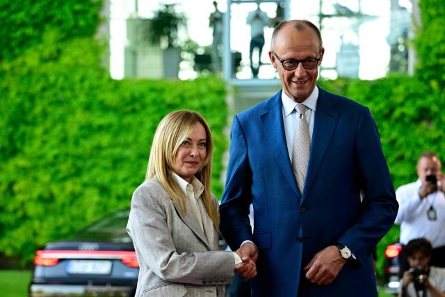 German Chancellor Friedrich Merz (R) welcomes Italy's Prime Minister Giorgia Meloni as he arrives for a meeting with state leaders of the European Group of Five (E5) and the NATO Secretary General on June 24, 2026 at the Chancellery in Berlin, Germany. (Photo by Tobias SCHWARZ / AFP)