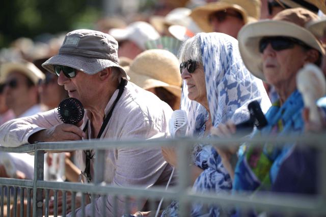 Spectators use portable fans during the Giorgio Armani Tennis Classic tournament at the Hurlingham Club in London on June 24, 2026. (Photo by Henry NICHOLLS / AFP)