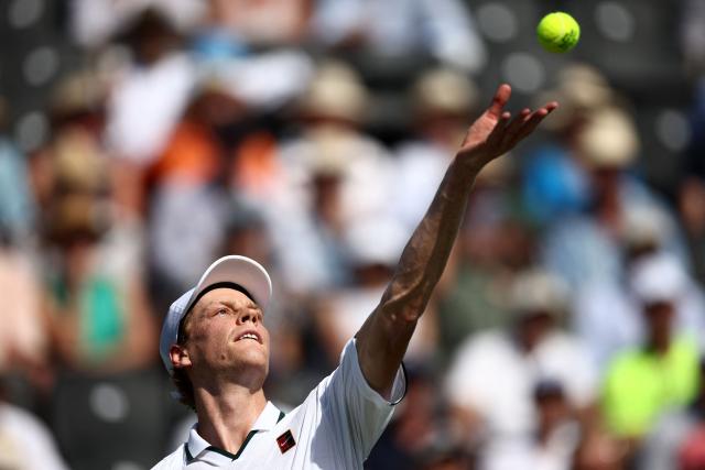 Italy's Jannik Sinner throws the ball to serve against Britain's Cameron Norrie during their men's singles exhibition match during the Giorgio Armani Tennis Classic tournament at the Hurlingham Club in London on June 24, 2026. (Photo by Henry Nicholls / AFP)