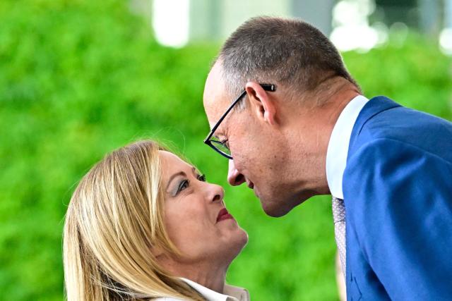 German Chancellor Friedrich Merz (R) welcomes Italy's Prime Minister Giorgia Meloni as he arrives for a meeting with state leaders of the European Group of Five (E5) and the NATO Secretary General on June 24, 2026 at the Chancellery in Berlin, Germany. (Photo by Tobias SCHWARZ / AFP)