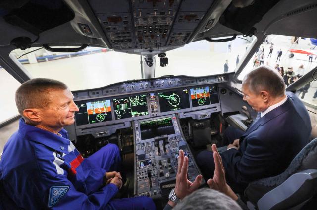 In this pool photograph distributed by the Russian state agency Sputnik, Russia's President Vladimir Putin inspects a Yakovlev SJ-100 short-haul jet aircraft at the Flight Research Institute named after M.M. Gromov in Zhukovsky in the Moscow region on June 24, 2026. (Photo by Mikhail METZEL / POOL / AFP)