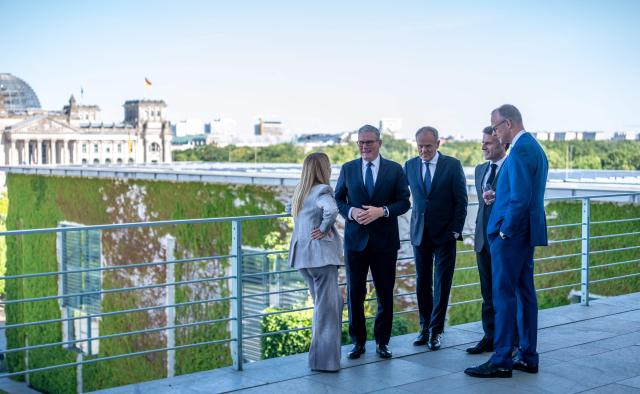 (L-R) Italy's Prime Minister Giorgia Meloni, Britain's Prime Minister Keir Starmer, Poland's Prime Minister Donald Tusk, France's President Emmanuel Macron and German Chancellor Friedrich Merz talk on a terrace of the Chancellery at the start of a meeting with state leaders of the European Group of Five (E5) and the NATO Secretary General on June 24, 2026 at the Chancellery in Berlin, Germany. (Photo by Michael Kappeler / POOL / AFP)