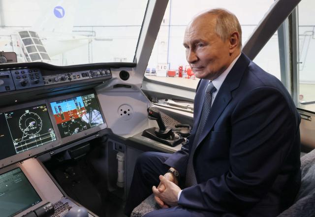 In this pool photograph distributed by the Russian state agency Sputnik, Russia's President Vladimir Putin inspects a Yakovlev MC-21 medium-haul airliner at the Flight Research Institute named after M.M. Gromov in Zhukovsky in the Moscow region on June 24, 2026. (Photo by Mikhail METZEL / POOL / AFP)