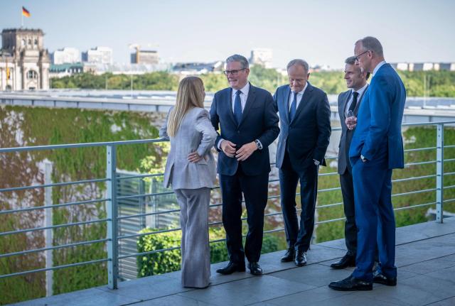 (L-R) Italy's Prime Minister Giorgia Meloni, Britain's Prime Minister Keir Starmer, Poland's Prime Minister Donald Tusk, France's President Emmanuel Macron and German Chancellor Friedrich Merz talk on a terrace of the Chancellery at the start of a meeting with state leaders of the European Group of Five (E5) and the NATO Secretary General on June 24, 2026 at the Chancellery in Berlin, Germany. (Photo by Michael Kappeler / POOL / AFP)