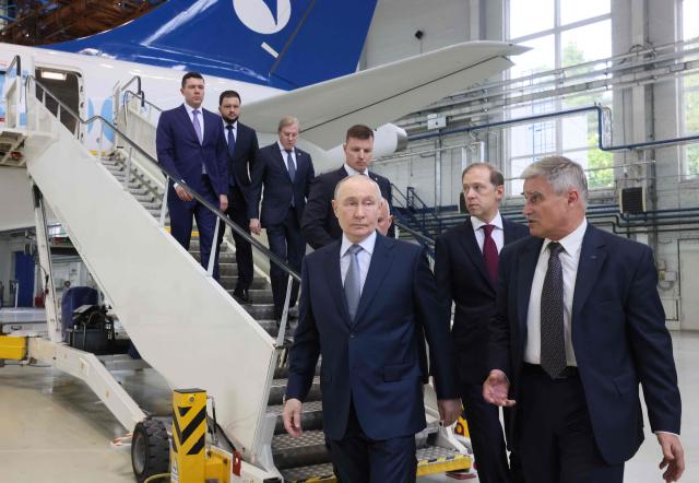 In this pool photograph distributed by the Russian state agency Sputnik, Russia's President Vladimir Putin inspects a Yakovlev SJ-100 short-haul jet aircraft at the Flight Research Institute named after M.M. Gromov in Zhukovsky in the Moscow region on June 24, 2026. (Photo by Mikhail METZEL / POOL / AFP)
