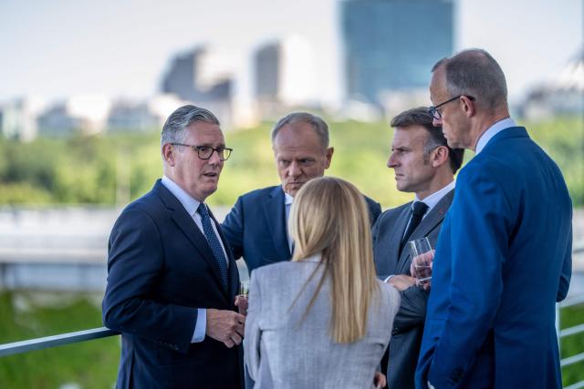 (L-R) Britain's Prime Minister Keir Starmer, Poland's Prime Minister Donald Tusk, Italy's Prime Minister Giorgia Meloni, France's President Emmanuel Macron and German Chancellor Friedrich Merz talk on a terrace of the Chancellery at the start of a meeting with state leaders of the European Group of Five (E5) and the NATO Secretary General on June 24, 2026 at the Chancellery in Berlin, Germany. (Photo by Michael Kappeler / POOL / AFP)