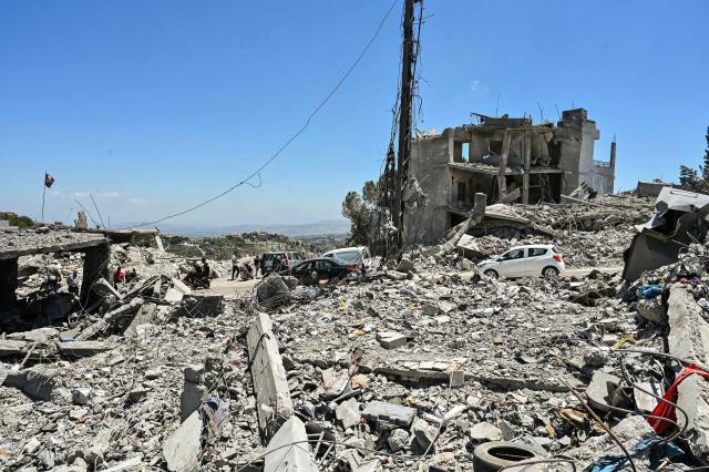 Residents drive past collapsed homes, destroyed in Israeli military strikes, as they return to check on their properties in the southern Lebanese village of Srifa on June 24, 2026. Israeli Defence Minister said June 24, that the United States has not demanded that Israel withdraw its troops from southern Lebanon, a condition set by Lebanon in ongoing ceasefire negotiations. Lebanese President rejected Israel's occupation of the south and foreign interference in his country's affairs -- an allusion to Hezbollah's backer Iran -- as a fifth round of Israel-Lebanon talks began in Washington on June 23. (Photo by FADEL itani / AFP) / 