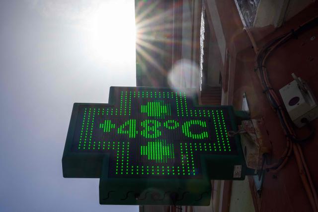 (FILES) This photograph shows a pharmacy sign displaying the temperature of 48 degrees celsius in Toulouse on June 24, 2026, as a heatwave hits France. France experienced its hottest day ever recorded on June 24, 2026, surpassing the record set the previous day, according to national weather service Meteo-France. (Photo by Lionel BONAVENTURE / AFP)
