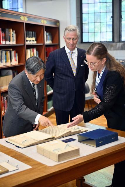 Japan's Emperor Naruhito (L) and King Philippe - Filip of Belgium (C) attend a visit at the KU Leuven (Katholieke Universiteit Leuven) university in Leuven on June 24, 2026, as part of an official state visit of the Japanese Emperor and Empress to Belgium. (Photo by ERIC LALMAND / Belga / AFP) / Belgium OUT