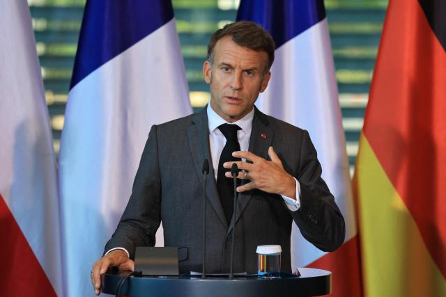 France's President Emmanuel Macron addresss the press at the end of the meeting of state leaders of the European Group of Five (E5) and the NATO Secretary General, on June 24, 2026 at the Chancellery in Berlin, Germany. (Photo by Ludovic MARIN / AFP)