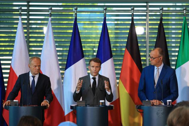 (L-R) Poland's Prime Minister Donald Tusk, France's President Emmanuel Macron and German Chancellor Friedrich Merz address the press at the end of their meeting of state leaders of the European Group of Five (E5) and the NATO Secretary General, on June 24, 2026 at the Chancellery in Berlin, Germany. (Photo by Ludovic MARIN / AFP)