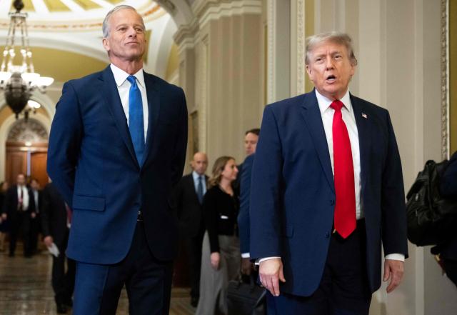 US President Donald Trump walks with Senate Majority Leader John Thune, Republican from South Dakota, on the way to a lunch meeting with Senate Republicans at the US Capitol in Washington, DC, on June 24, 2026. President Trump said Wednesday he will refuse to sign a landmark housing bill, passed by Congress with broad bipartisan support, until lawmakers approve legislation that would overhaul American elections and restrict voter registration. (Photo by SAUL LOEB / AFP)