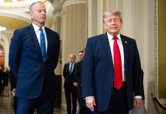 TOPSHOT - US President Donald Trump, alongside Senate Majority Leader John Thune, Republican from South Dakota, speaks to the press on the way to a lunch meeting with Senate Republicans at the US Capitol in Washington, DC, on June 24, 2026. President Trump said Wednesday he will refuse to sign a landmark housing bill, passed by Congress with broad bipartisan support, until lawmakers approve legislation that would overhaul American elections and restrict voter registration. (Photo by SAUL LOEB / AFP)